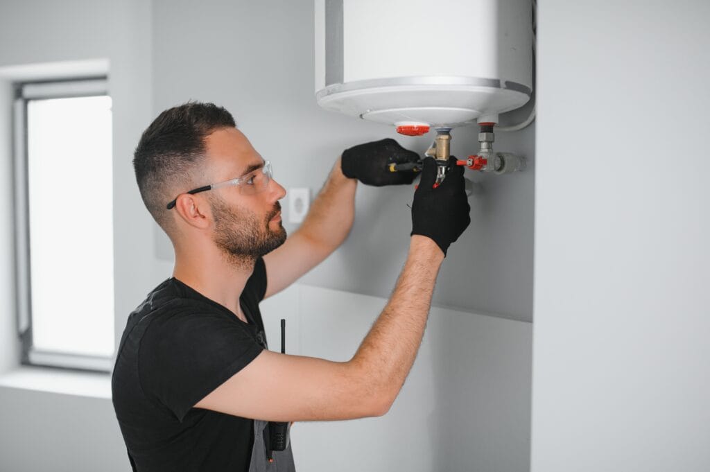 Technician performing water heater maintenance in Bethlehem