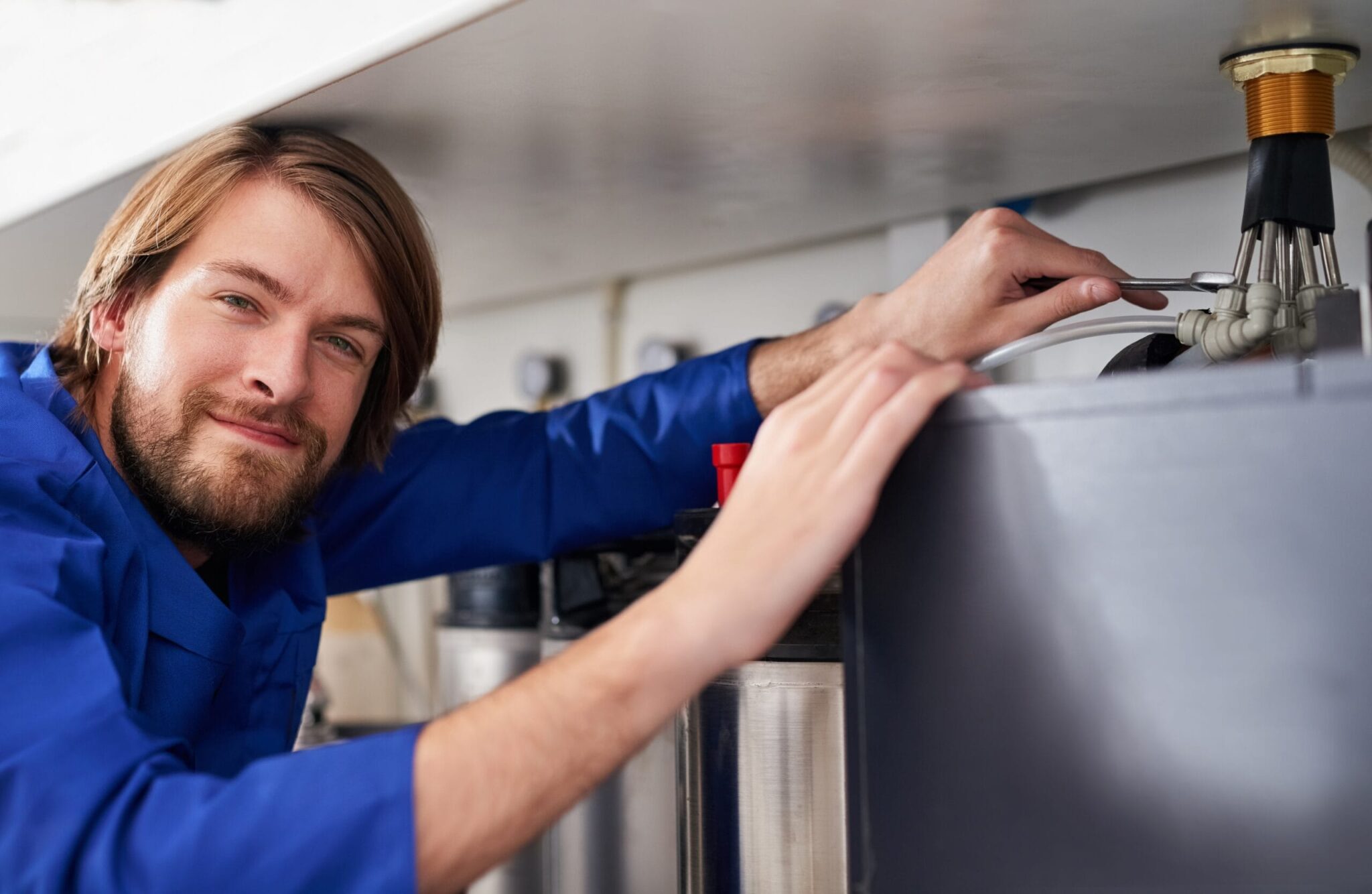 Technician servicing a residential water heater tank in Bethlehem